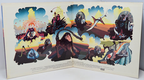 Colorful album cover with artistic illustrations of people and animals against a sunset sky.