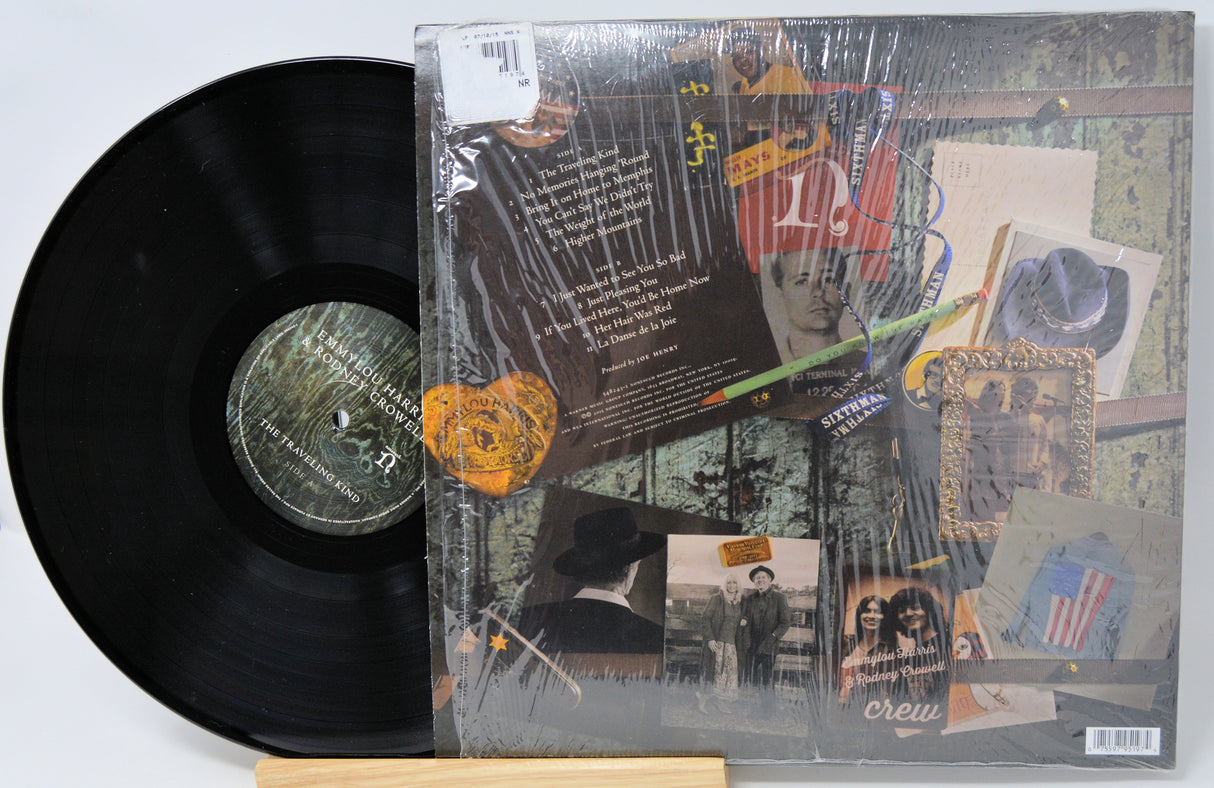 Vinyl record with a colorful cover featuring text and images on a light gray background
