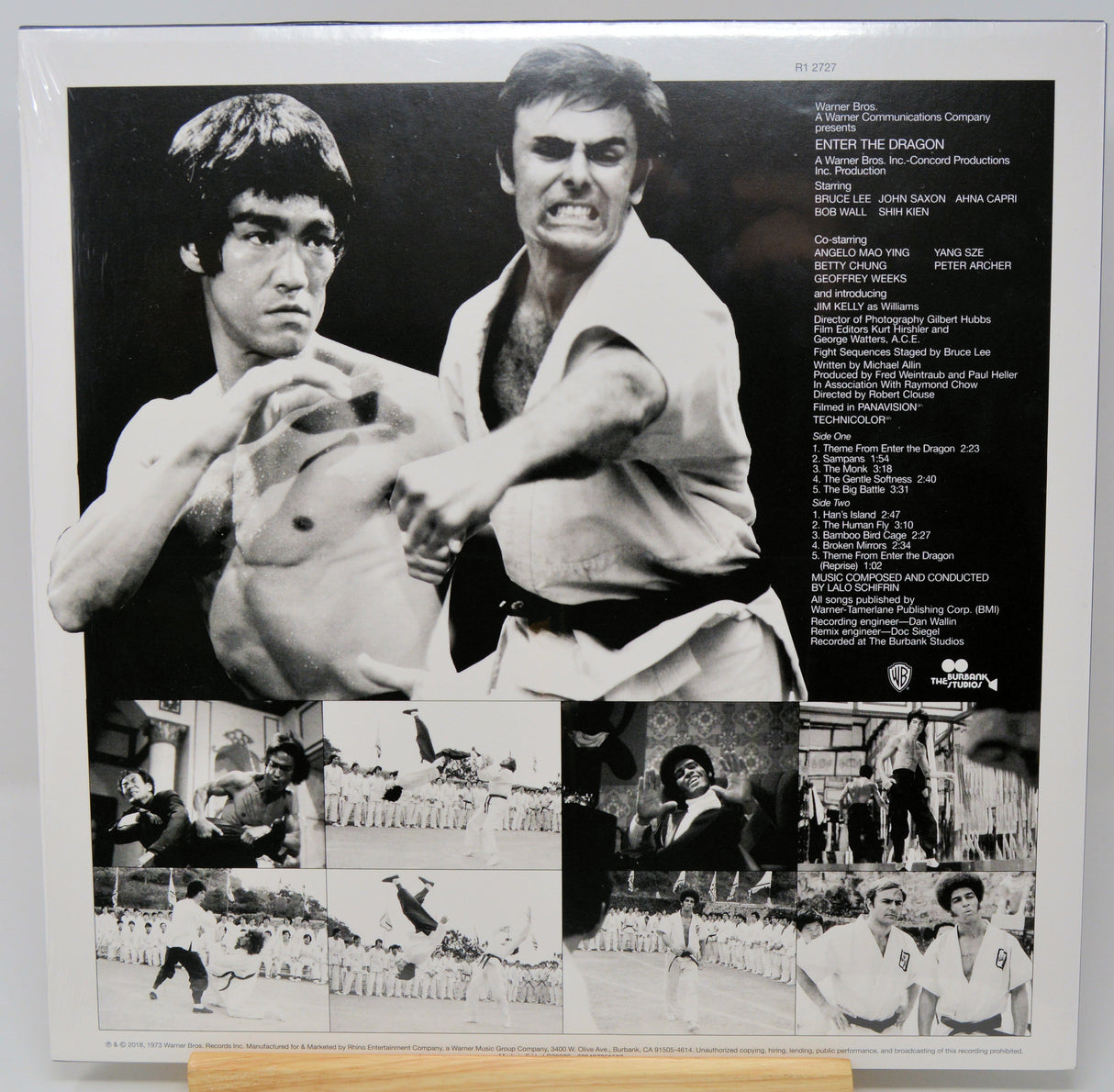 Black and white collage of two men in martial arts poses with additional images and text on a poster.