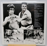Black and white collage of two men in martial arts poses with additional images and text on a poster.