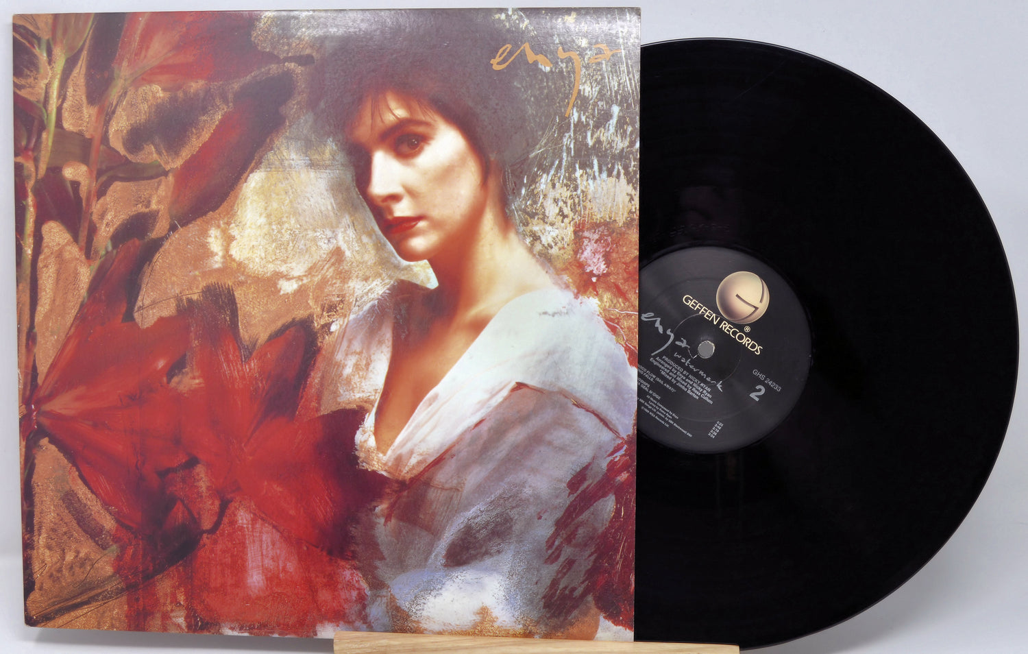 Vinyl record with a colorful cover featuring a woman's portrait and a red flower.