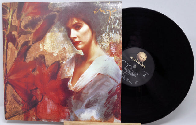 Vinyl record with a colorful cover featuring a woman's portrait and a red flower.