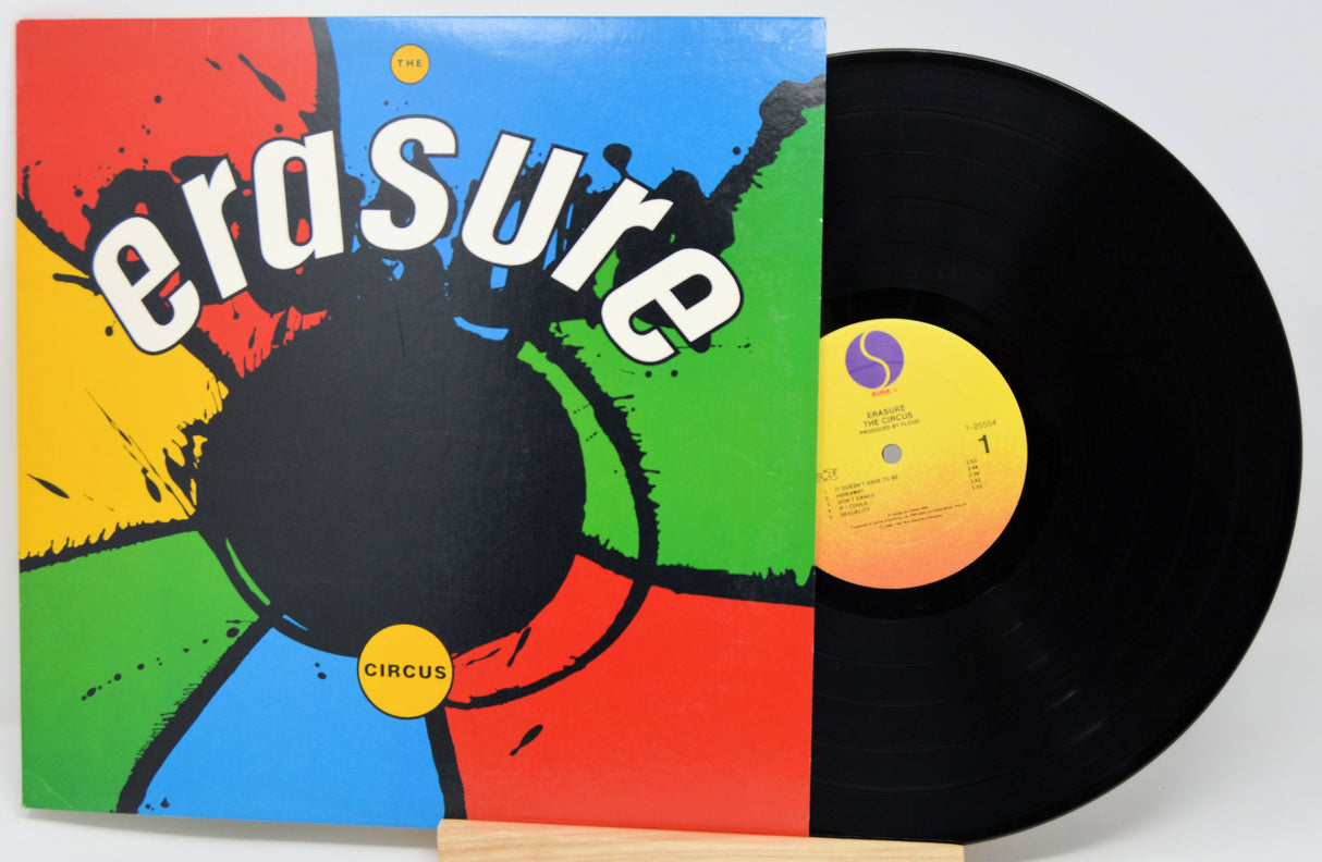 Vinyl record with colorful 'erasure' album cover on a white background