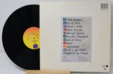 Vinyl record with cover displaying album tracklist on a white background