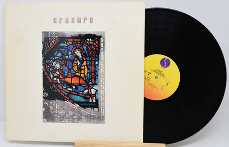 Vinyl record and cover with stained glass design and 'erasure' text