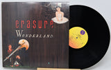 Vinyl record with 'erasure Wonderland' album cover featuring artistic illustrations.