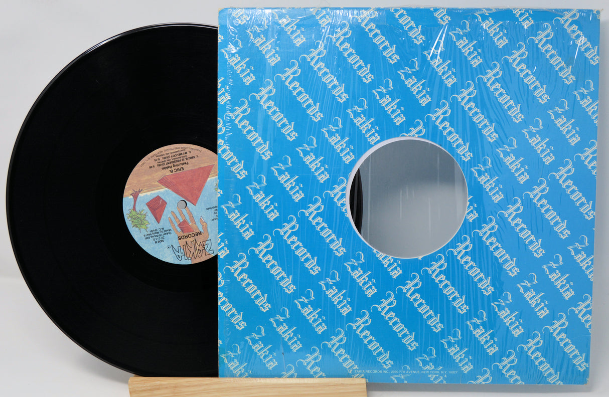 Vinyl record with a blue Zadra Records sleeve on a light gray background