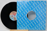 Vinyl record with a blue Zadra Records sleeve on a light gray background