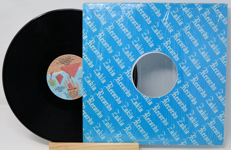 Vinyl record with a blue Zadra Records sleeve on a light gray background
