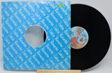 Vinyl record with a blue sleeve featuring text and a small label on a white background