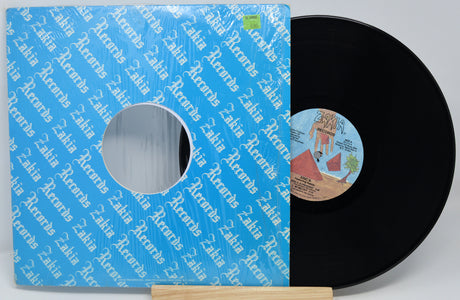 Vinyl record with a blue sleeve featuring text and a small label on a white background