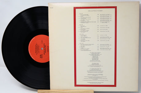 Vinyl record with red label and matching cover on a light gray background