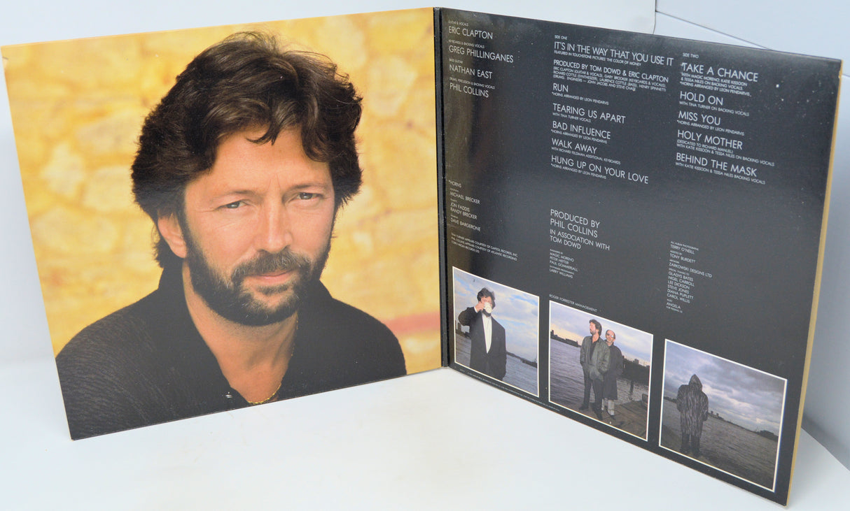 Vinyl record cover with a portrait of a person on one side and a list of songs on the other, featuring a yellow and black color scheme.