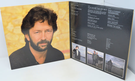 Vinyl record cover with a portrait of a person on one side and a list of songs on the other, featuring a yellow and black color scheme.