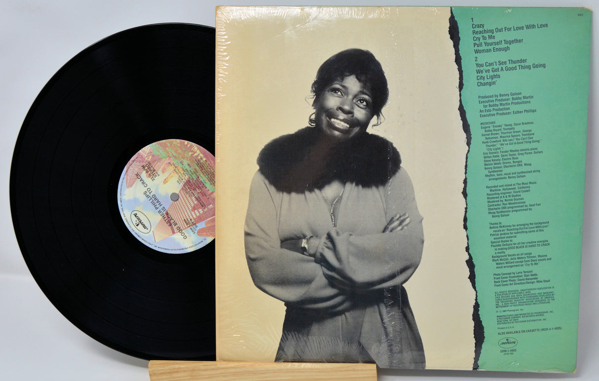Vinyl record with cover featuring a person, visible text, and colorful label.