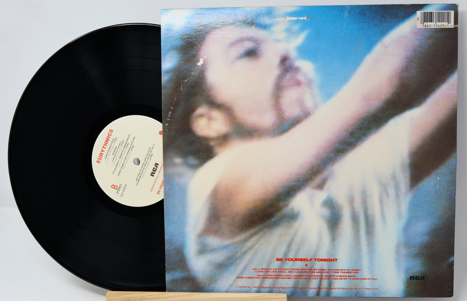 Vinyl record with a cover featuring a person against a blue sky.