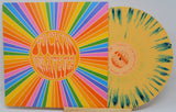 Front cover of F*ckin Whatever vinyl LP with rainbow psychedelic rays and yellow splatter vinyl