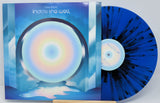 Front cover and blue splatter vinyl record of Fake Fever's Inside the Well featuring circular rainbow artwork