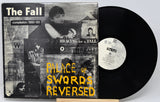 Vinyl record and cover titled 'Palace of Swords Reversed' by The Fall on a white background
