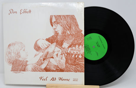 Front cover of Don Ebbett's Feel At Home vinyl album with artistic guitar illustration