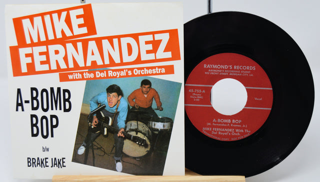 Vinyl record and cover with 'Mike Fernandez' and 'A-Bomb Bop' text on a white background