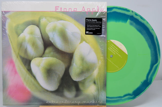 Vinyl record by Fiona Apple titled 'Extraordinary Machine' with a colorful cover featuring green and blue colors.