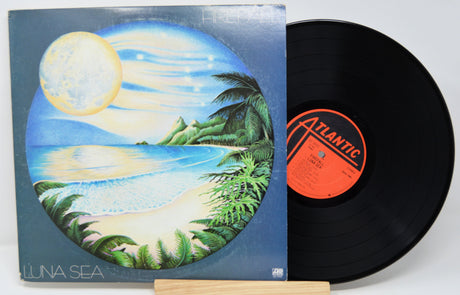 Vinyl record by Firefall titled Luna Sea with a tropical beach design on the cover and 'Atlantic' label.