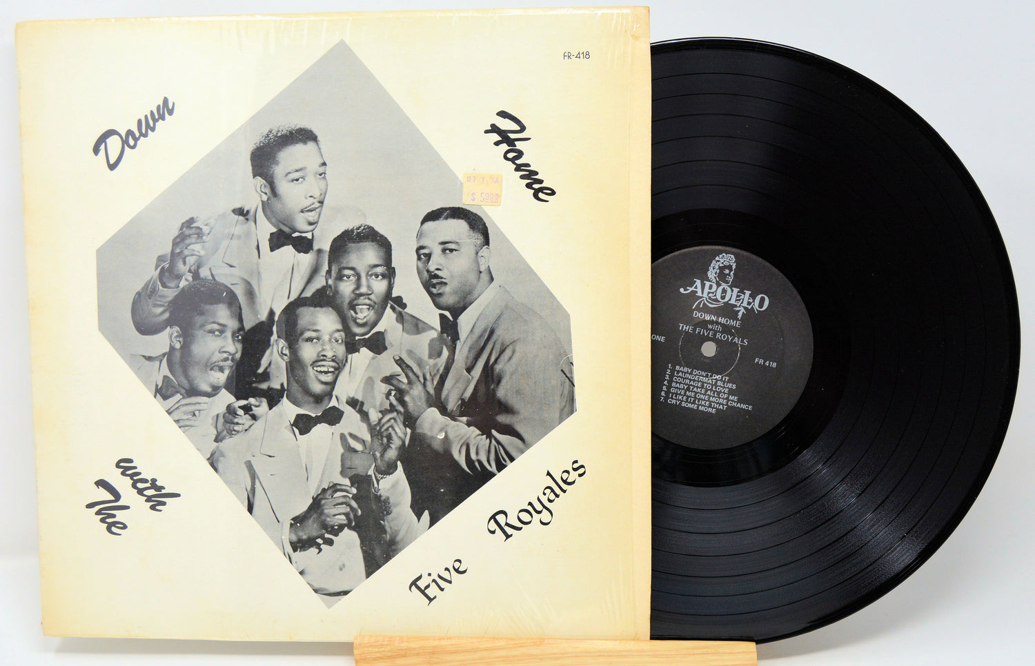 Vinyl record with cover featuring a group of men and album details.