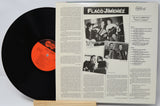 Vinyl record with a white sleeve featuring text and images of a musician.