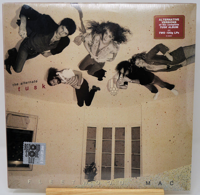 Fleetwood Mac - The Alternative Tusk vinyl record album, sealed in its original shrink wrap. The cover art features a beige-toned illustration of four people floating in the air above a house with windows.