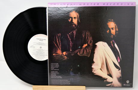 Vinyl record with a cover featuring two men, on a white background
