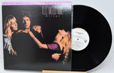 Vinyl record with 'Fleetwood Mac Mirage' cover showing band members.