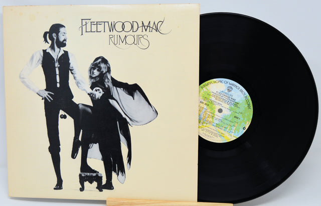 Vinyl record with 'Fleetwood Mac Rumours' cover showing two figures.