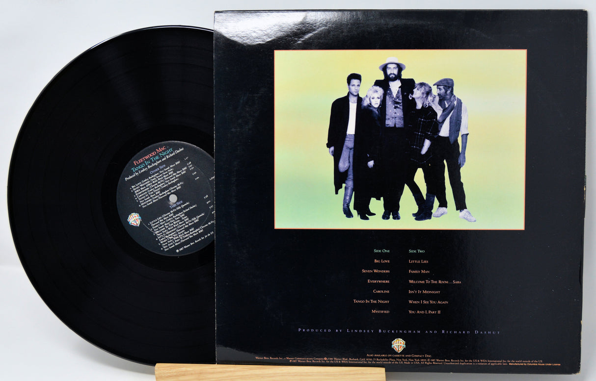 Vinyl record with a cover featuring a group of people on a yellow background