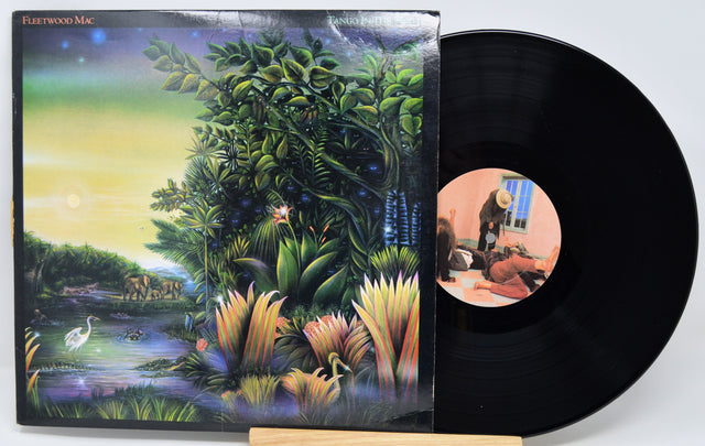 Vinyl record with a colorful cover featuring nature scenes