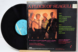 Vinyl record with 'A Flock of Seagulls' album cover showing four band members.