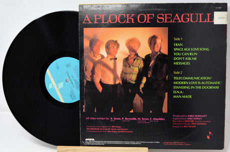 Vinyl record with 'A Flock of Seagulls' album cover showing four band members.