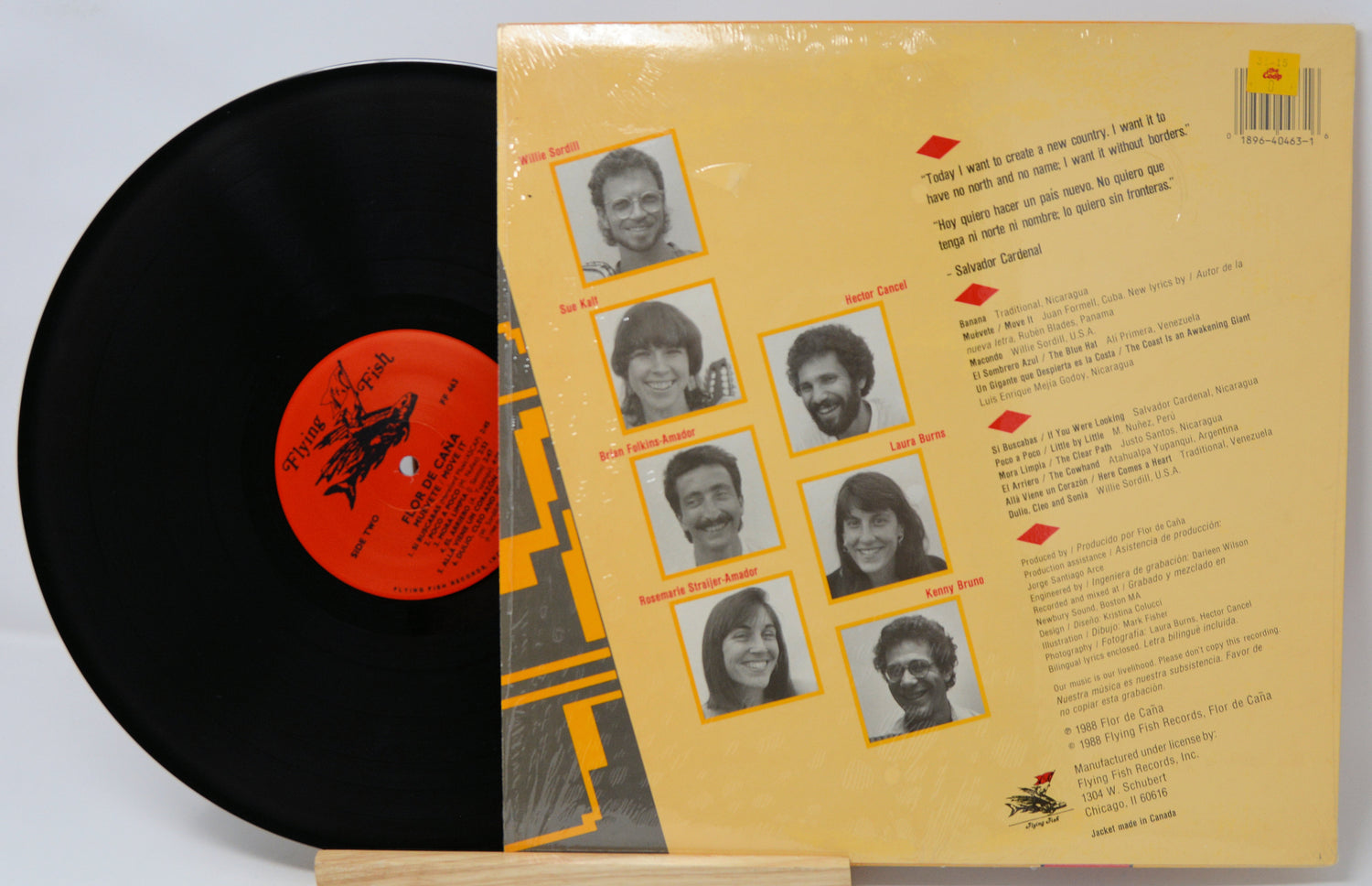 Vinyl record with a yellow cover featuring black and white portraits and text.