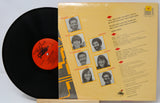 Vinyl record with a yellow cover featuring black and white portraits and text.