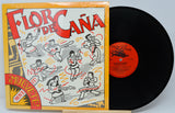 Vinyl record with colorful cover featuring dancing figures and text.