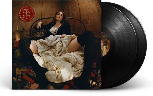 Vinyl record with a cover featuring a person lying on a bed in a wooden room.