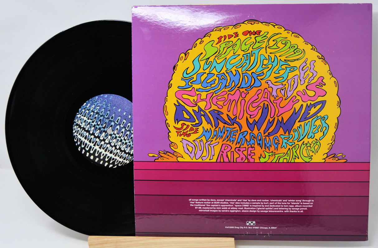 Vinyl record with a colorful cover featuring text and graphics on a white background