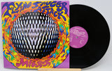 Vinyl record with colorful cover featuring 'Flying Saucer Attack' text