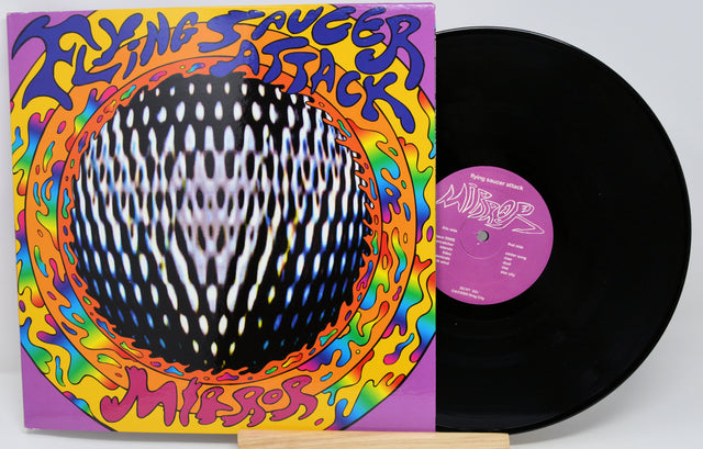Vinyl record with colorful cover featuring 'Flying Saucer Attack' text