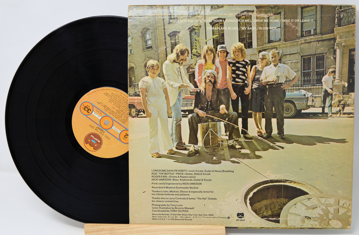 Vinyl record with a cover featuring a group of people outdoors.