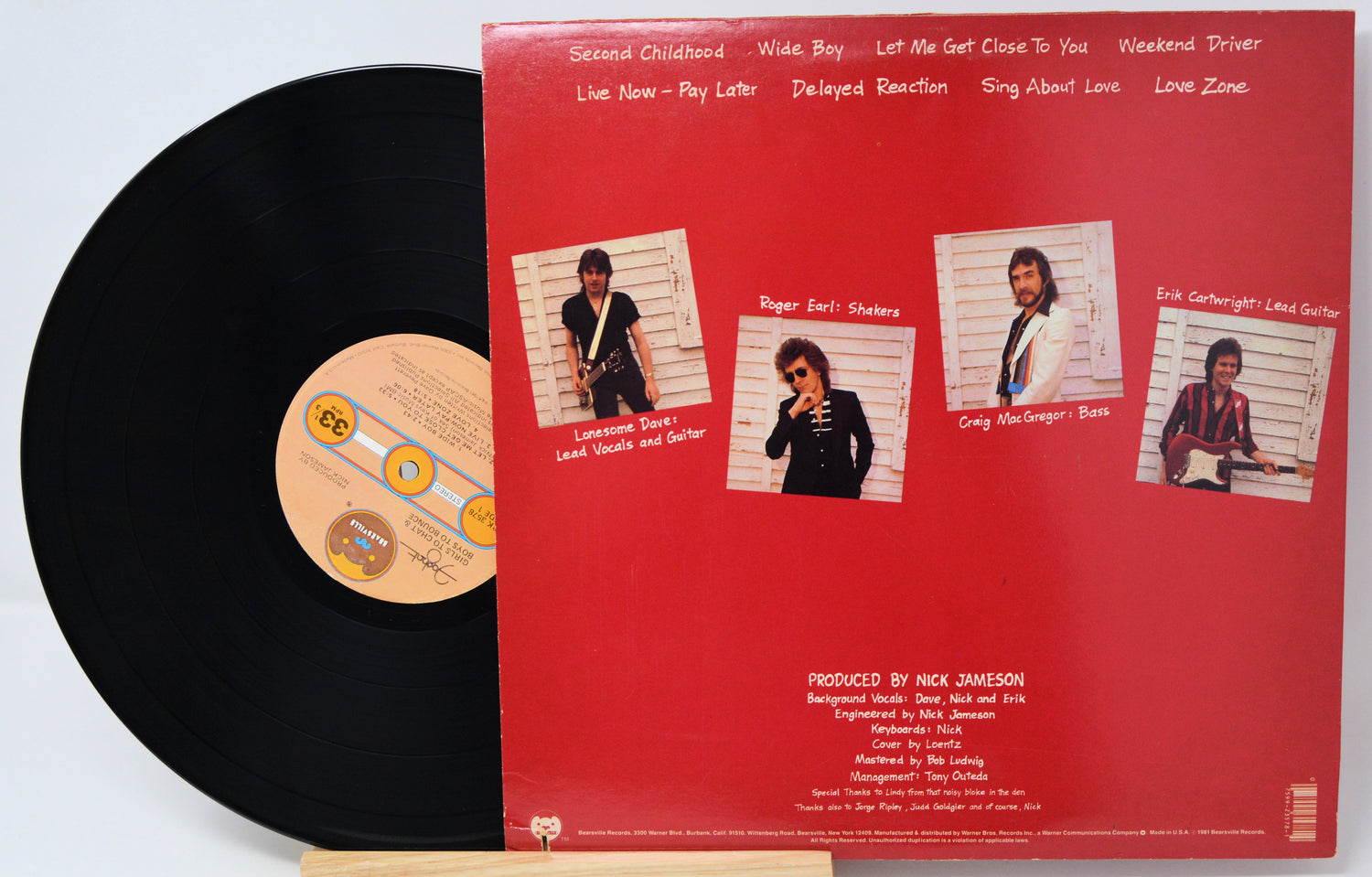Vinyl record with a red label featuring album tracklist and cover images.