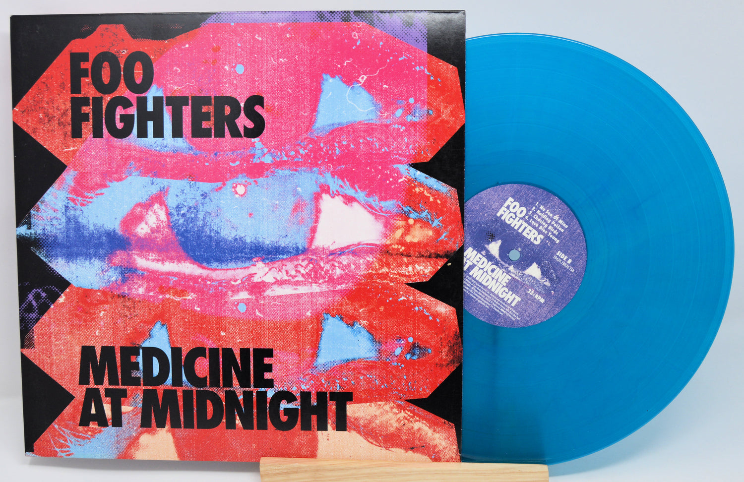Vinyl cover featuring colorful blue and red artwork for Foo Fighters Medicine At Midnight