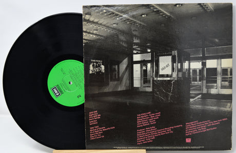 Vinyl record with a black cover featuring an interior scene and a green label.