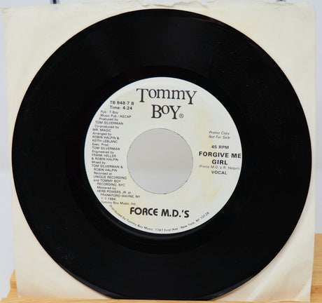 Vinyl record with 'Tommy Boy' label on a white background