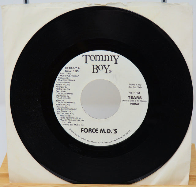 Vinyl record with 'Tommy Boy' label and 'Force M.D.'s' on a white background